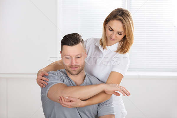 Woman Waxing Man's Chest With Wax Strip Stock photo © AndreyPopov