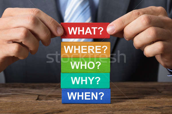 Businessman Building Blocks With Question Words On Wood Stock photo © AndreyPopov