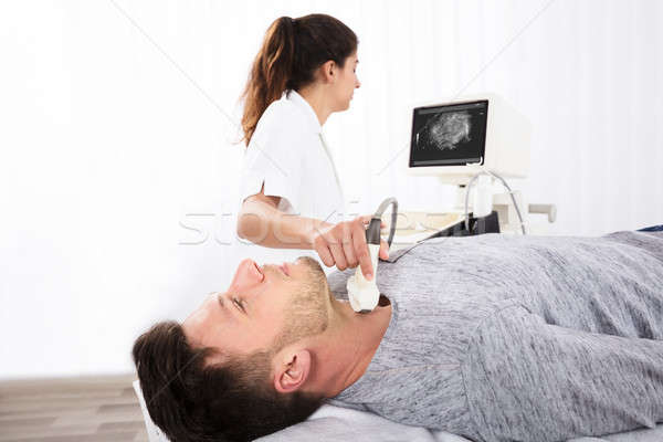 Man Getting Ultrasound Of A Thyroid From Doctor Stock photo © AndreyPopov