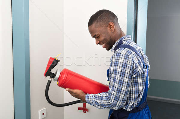 Male African Professional Holding Fire Extinguisher Stock photo © AndreyPopov