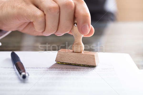 Stock photo: Human Hand Stamping Document