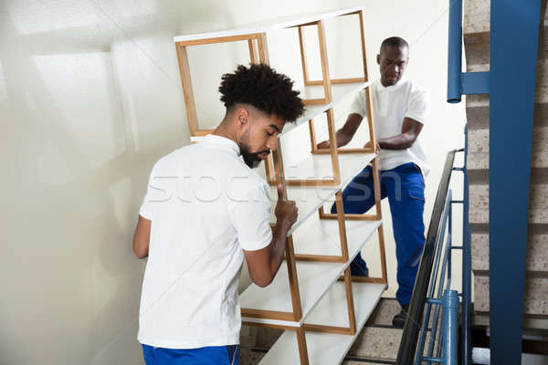 Two Male Movers Carrying The Empty Shelf At Home Stock photo © AndreyPopov