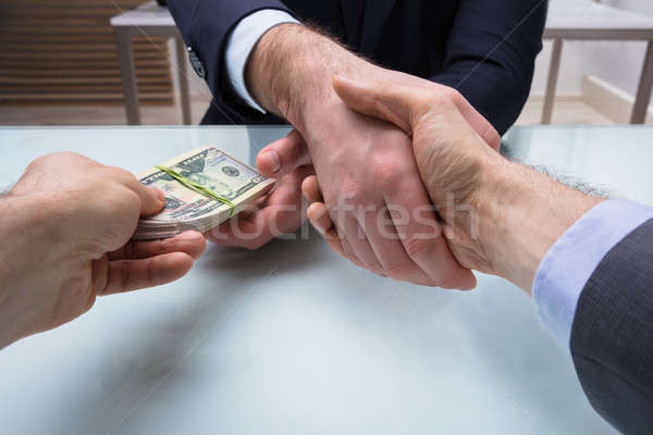 Two Business Partners Shaking Hand At Workplace Stock photo © AndreyPopov