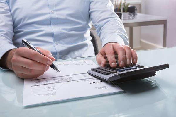 Businessperson Calculating Invoice Stock photo © AndreyPopov