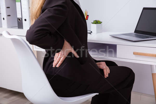 Femeie de afaceri dureri de spate matur la locul de muncă calculator Imagine de stoc © AndreyPopov