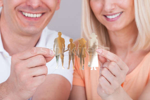 Couple holding family figure cut-out Stock photo © AndreyPopov