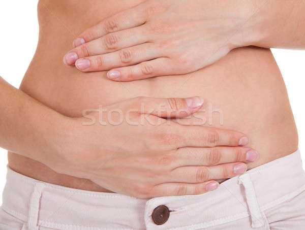 Close up of woman's hands on belly Stock photo © AndreyPopov