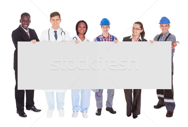 Stock photo: Smiling People With Various Occupations Holding Blank Billboard