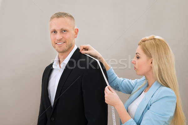 Female Tailor Taking Measurement Of Suit Stock photo © AndreyPopov