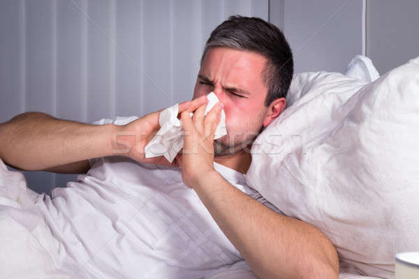 Hombre sonarse la nariz infectado frío gripe Foto stock © AndreyPopov