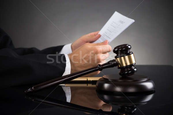 Judge Holding Document At Desk Stock photo © AndreyPopov