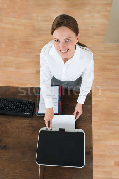 Young Businesswoman Using Printer In Office Stock photo © AndreyPopov