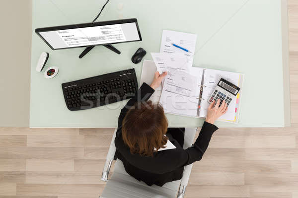 Businesswoman Calculating Financial Report Stock photo © AndreyPopov
