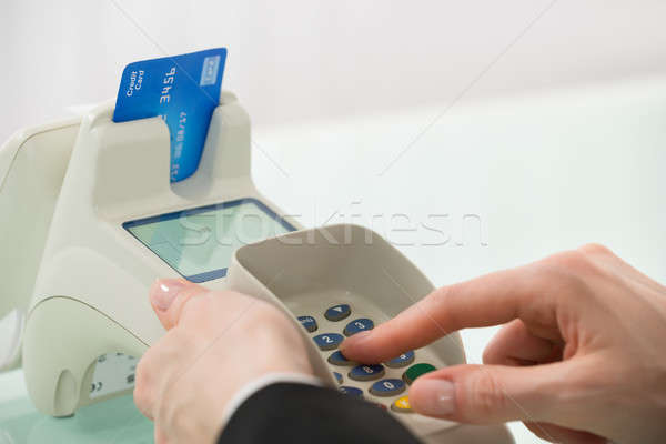 Woman Pressing Button On Credit Card Machine Stock photo © AndreyPopov