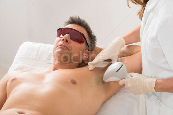 Beautician Giving Hair Removal Treatment To Man Stock photo © AndreyPopov