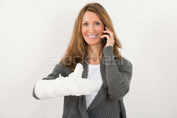 Woman With Broken Hand Talking On Mobile Phone Stock photo © AndreyPopov