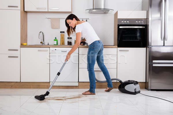 Woman Cleaning The Dust Floor Of The Kitchen Stock photo © AndreyPopov