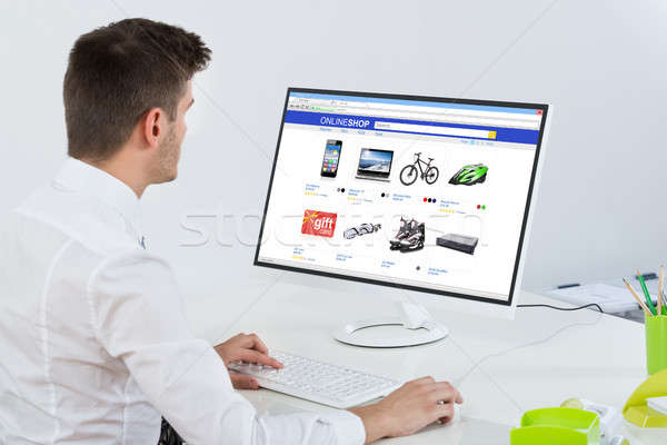 Male Employee Shopping Online On Desktop Stock photo © AndreyPopov