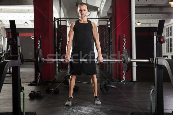 Junger Mann Heben Langhantel Mann Sport Fitnessstudio Stock foto © AndreyPopov