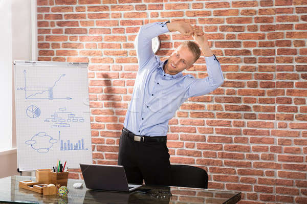 Man Exercising In Office Stock photo © AndreyPopov