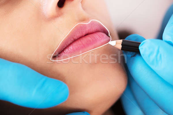 Cosmetologist Applying Permanent Make Up Stock photo © AndreyPopov