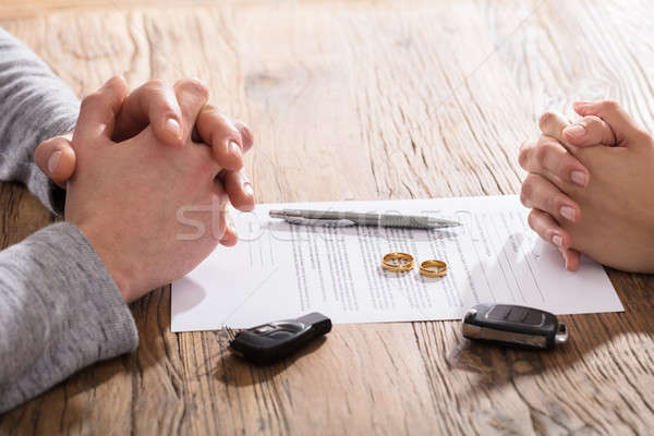 Stock photo: Couple's Hand On Divorce Agreement Wit Car Keys