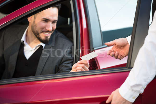 Valet Giving Receipt To Businessperson Sitting Inside Car Stock photo © AndreyPopov