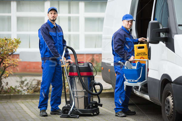 Two Male Janitor Unloading Cleaning Equipment From Vehicle Stock photo © AndreyPopov