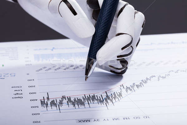 Robot Holding Pen Over Financial Document Stock photo © AndreyPopov