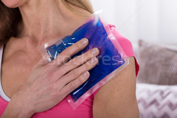 Woman Applying Ice Bag On Her Shoulder Stock photo © AndreyPopov