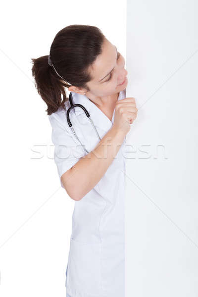 Doctor or nurse with blank signboard Stock photo © AndreyPopov