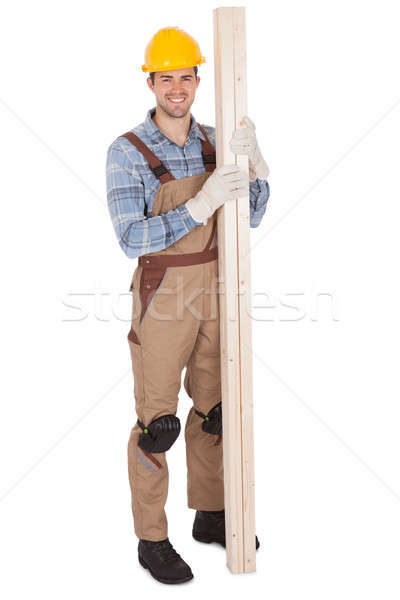 Worker wearing hard hat and holding timber Stock photo © AndreyPopov