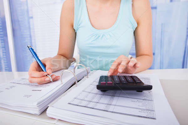 Stock photo: Woman Calculating Home Finances At Desk