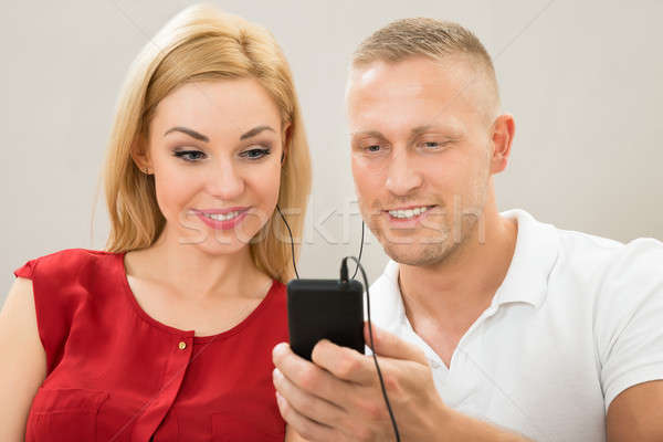 Stock photo: Couple Listening To Music With Mobile Phone