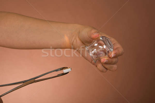 Person Holding Lit Camphor And Cup Stock photo © AndreyPopov