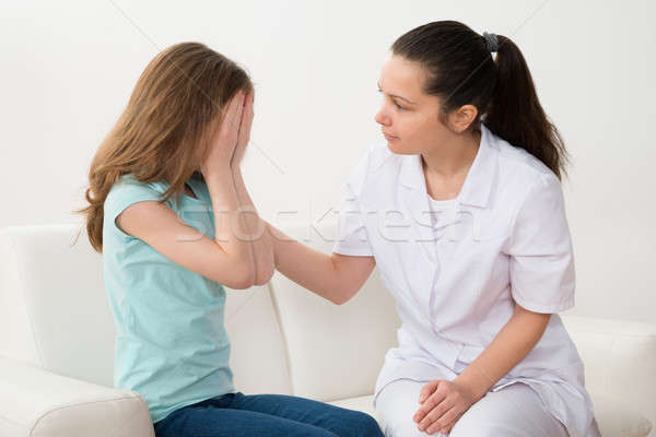 Doctor Comforting Patient Crying Stock photo © AndreyPopov