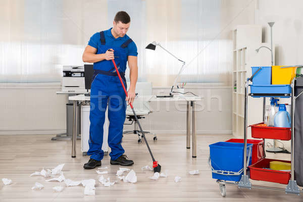 Janitor Cleaning Floor With Broom In Office Stock photo © AndreyPopov