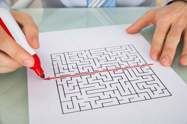 Person Hand Drawing Straight Red Line Over Maze Stock photo © AndreyPopov