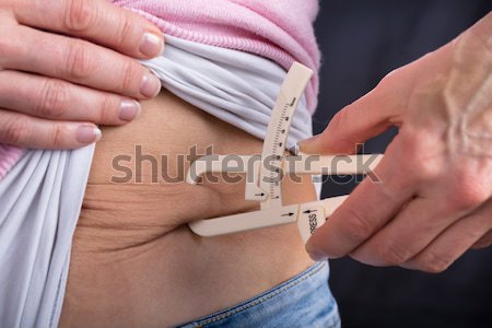 Man Measuring Fats With Caliper Stock photo © AndreyPopov
