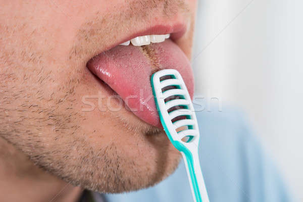 Man Cleaning Her Tongue Stock photo © AndreyPopov