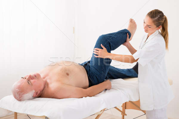 Stock photo: Masseur Giving Leg Massage To Man