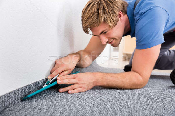 Craftsman Cutting Carpet With Cutter Stock photo © AndreyPopov