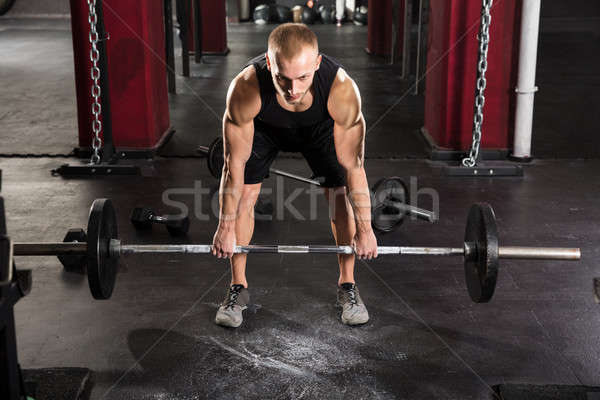 Jeune homme barbell homme sport gymnase [[stock_photo]] © AndreyPopov