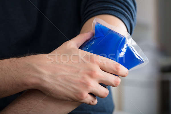 Person Applying Ice Gel Pack On An Injured Elbow Stock photo © AndreyPopov