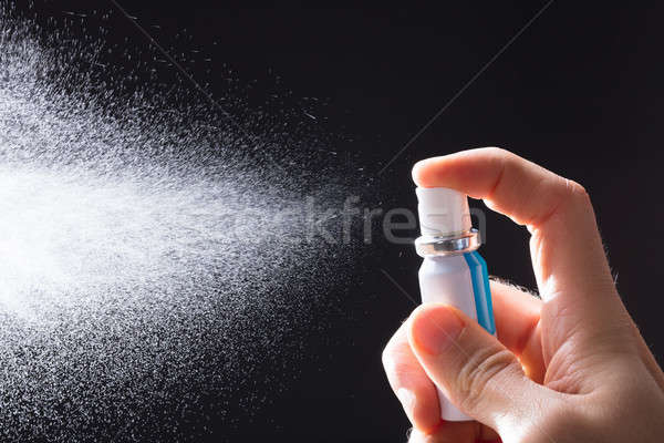 Person Spraying Breath Freshener Stock photo © AndreyPopov