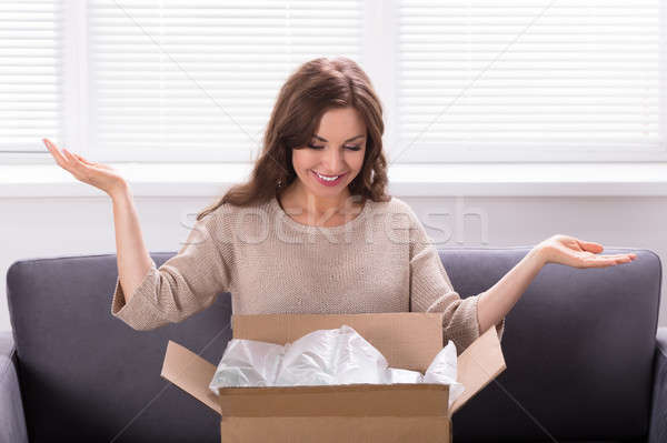 Woman Unpacking Received Parcel Stock photo © AndreyPopov