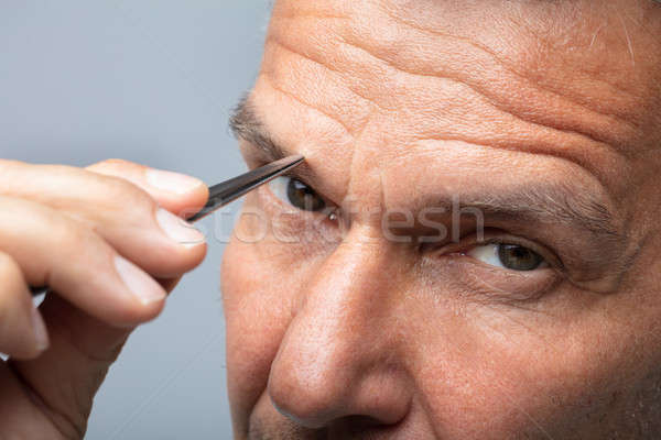 Man Plucking Eyebrow Hair Stock photo © AndreyPopov