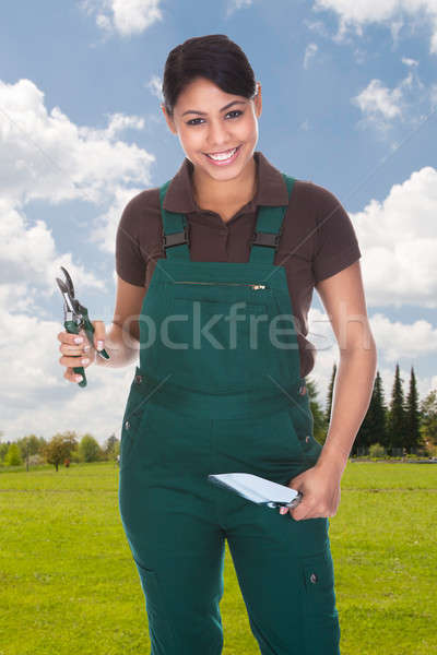 Stock photo: Female Gardener Holding Gardening Tools