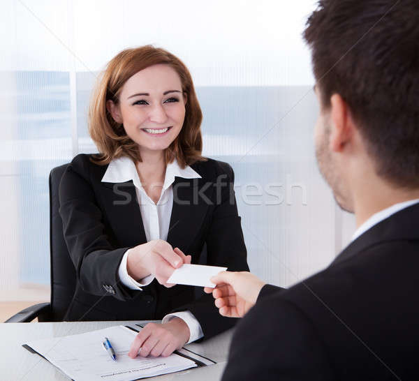 Two businesspeople exchanging visiting card Stock photo © AndreyPopov