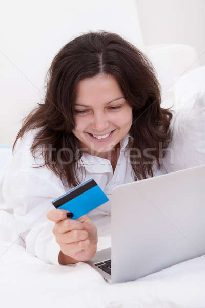 Excited woman making purchases online Stock photo © AndreyPopov